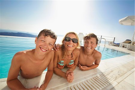 simsearch:400-05381058,k - Family smiling in swimming pool Stock Photo - Premium Royalty-Free, Code: 649-06001747