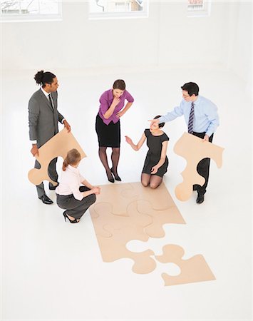 partner, concept - Business people doing puzzle in office Stock Photo - Premium Royalty-Free, Code: 649-06001897