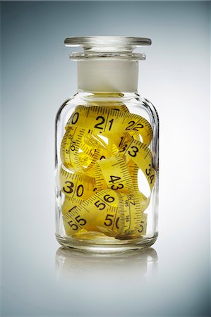 pharmaceuticals - Close up of measuring tape in jar Stock Photo - Premium Royalty-Free, Code: 649-06002008