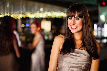 Smiling woman standing in bar Stock Photo - Premium Royalty-Free, Code: 649-06040174