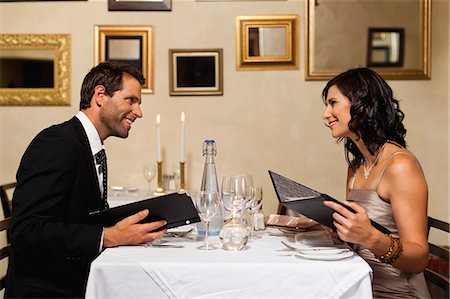 Couple examining menus in restaurant Stock Photo - Premium Royalty-Free, Code: 649-06040265