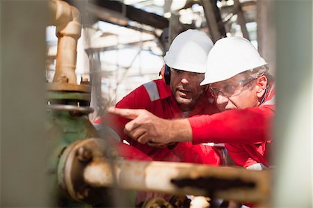 refinery - Workers examining equipment on site Stock Photo - Premium Royalty-Free, Code: 649-06040466