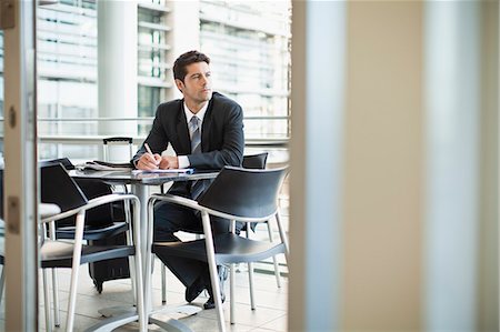 doorway - Businessman making notes in cafe Stock Photo - Premium Royalty-Free, Code: 649-06040583