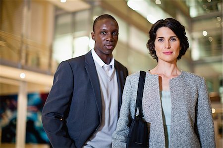 Smiling business people in lobby Stock Photo - Premium Royalty-Free, Code: 649-06040705