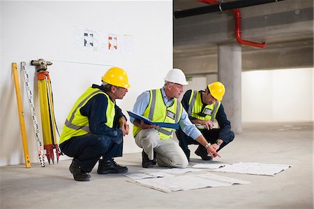 Workers reading blueprints on site Stock Photo - Premium Royalty-Free, Code: 649-06040776
