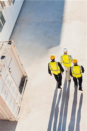 Workers casting shadows on site Stock Photo - Premium Royalty-Free, Code: 649-06040799