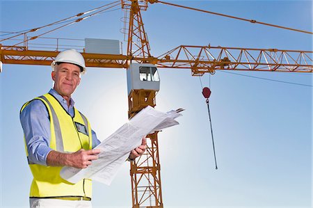 portrait outside work - Worker reading blueprints on site Stock Photo - Premium Royalty-Free, Code: 649-06040793