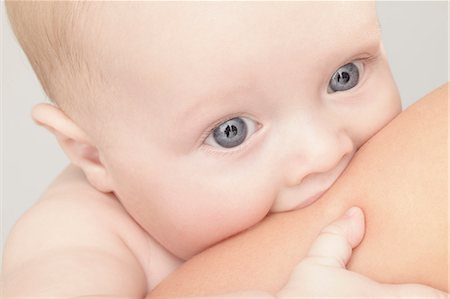 sucking - Close up of baby girl chewing on hand Stock Photo - Premium Royalty-Free, Code: 649-06040991