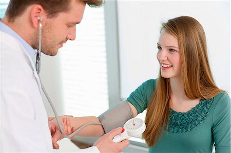 Doctor taking girls blood pressure Stock Photo - Premium Royalty-Free, Code: 649-06041106