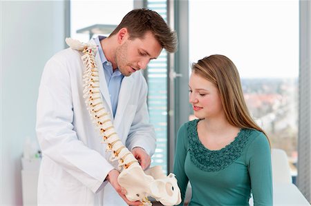 doctors together - Doctor showing spine model to patient Stock Photo - Premium Royalty-Free, Code: 649-06041107