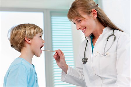 doctor examining boy - Doctor examining boy in office Stock Photo - Premium Royalty-Free, Code: 649-06041113