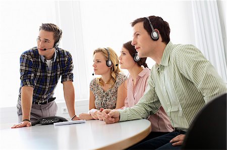 simsearch:6113-07243082,k - Business people in headsets in meeting Stock Photo - Premium Royalty-Free, Code: 649-06041181