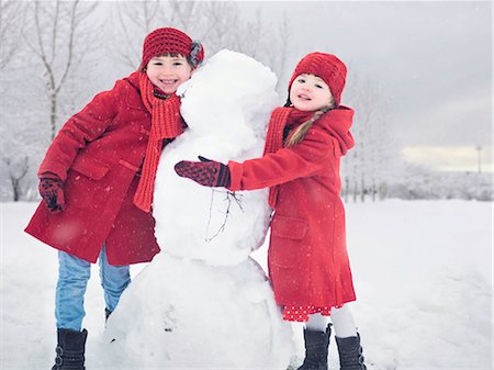 simsearch:649-06401393,k - Girls building snowman outdoors Stock Photo - Premium Royalty-Free, Code: 649-06041445