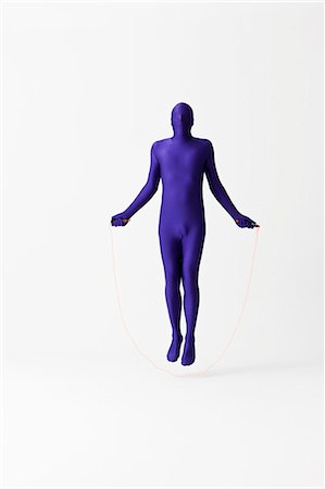 energy concept - Man in bodysuit jumping rope Stock Photo - Premium Royalty-Free, Code: 649-06041670
