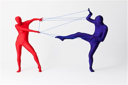 Couple in bodysuits playing with string Foto de stock - Royalty Free Premium, Número: 649-06041686