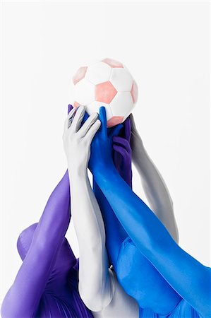 sports together - Men in bodysuits holding soccer ball Stock Photo - Premium Royalty-Free, Code: 649-06041748