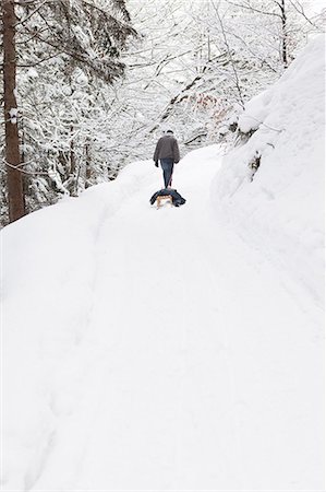 people walking in the distance - Man pulling sled in snowy field Stock Photo - Premium Royalty-Free, Code: 649-06041848