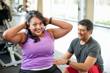 fat man exercising - Femme travaillant avec formateur dans la salle de gym Photographie de stock - Premium Libres de Droits, Code: 649-06042009