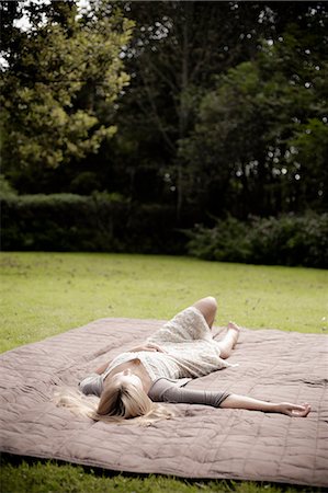 Woman laying on blanket in park Stock Photo - Premium Royalty-Free, Code: 649-06112529