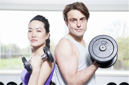 fitness asian couple - Couple lifting weights in gym Stock Photo - Premium Royalty-Free, Code: 649-06113453