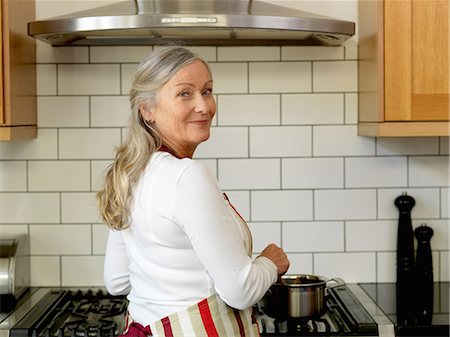 stove - Older woman cooking in kitchen Stock Photo - Premium Royalty-Free, Code: 649-06164542