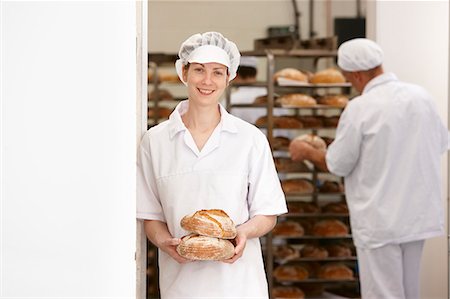 simsearch:649-06165027,k - Chef holding loaves of bread in kitchen Stock Photo - Premium Royalty-Free, Code: 649-06165042