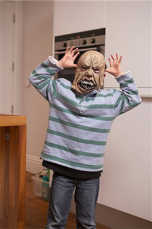 simsearch:649-06041783,k - Boy wearing Halloween mask in kitchen Stock Photo - Premium Royalty-Free, Code: 649-06165207