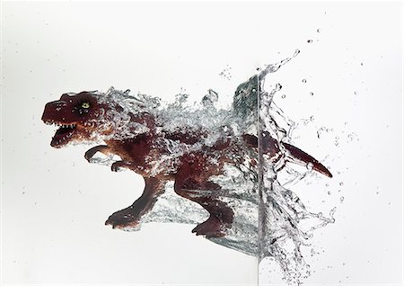 dinosaur - Toy dinosaur plunging into water Stock Photo - Premium Royalty-Free, Code: 649-06165325