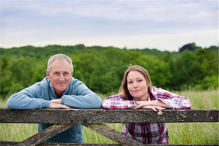 Father and daughter on wooden fence Stock Photo - Premium Royalty-Free, Code: 649-06304854