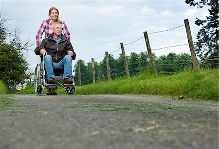 road bottom view - Woman pushing father in wheelchair Stock Photo - Premium Royalty-Free, Code: 649-06304858