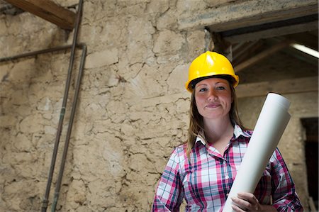 Construction worker carrying blueprints Stock Photo - Premium Royalty-Free, Code: 649-06304874