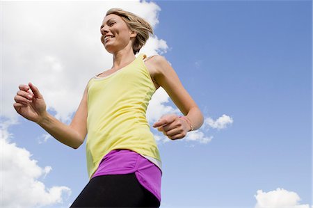 pictures of woman running with short hair - Woman jogging outdoors Stock Photo - Premium Royalty-Free, Code: 649-06305016
