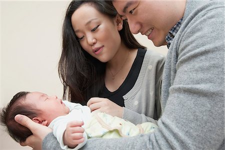 simsearch:6113-07543205,k - Parents holding sleeping baby Stock Photo - Premium Royalty-Free, Code: 649-06305034