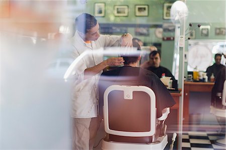 Barber working on client in shop Stock Photo - Premium Royalty-Free, Code: 649-06305057