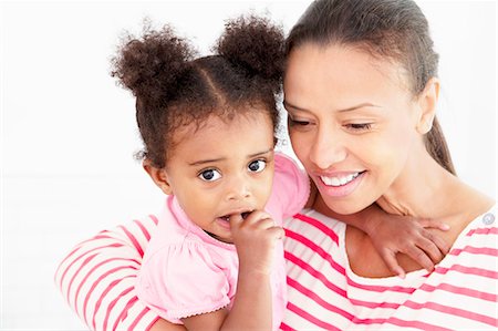 Smiling mother holding daughter Stock Photo - Premium Royalty-Free, Code: 649-06305122