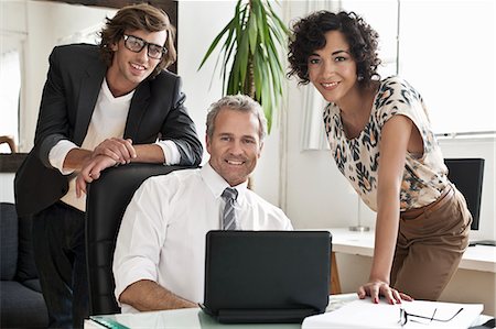 simsearch:649-05648787,k - Business people smiling at desk Stock Photo - Premium Royalty-Free, Code: 649-06305268