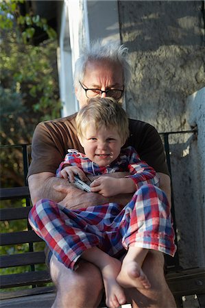 Older man hugging grandson outdoors Stock Photo - Premium Royalty-Free, Code: 649-06305334