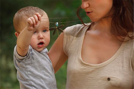 dragon fly - Toddler playing with mothers necklace Stock Photo - Premium Royalty-Free, Code: 649-06305536