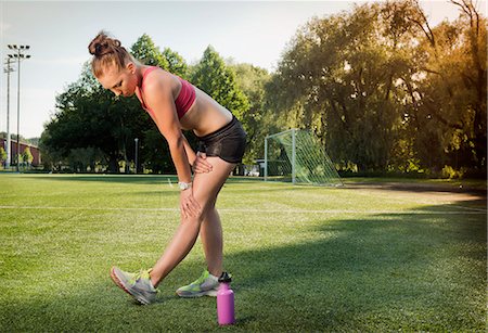 simsearch:649-04247797,k - Runner stretching on grass in park Stock Photo - Premium Royalty-Free, Code: 649-06305586