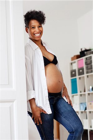 portrait of pregnant woman - Pregnant woman revealing belly Stock Photo - Premium Royalty-Free, Code: 649-06305762