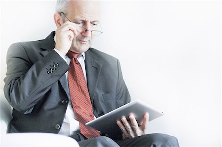 Businessman using tablet computer Stock Photo - Premium Royalty-Free, Code: 649-06305880