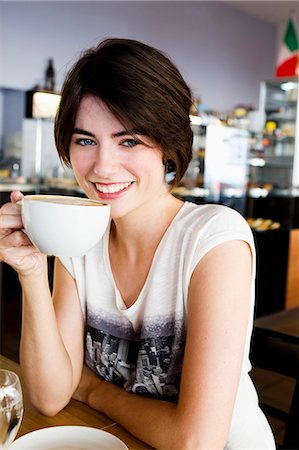 Smiling woman drinking coffee in cafe Stock Photo - Premium Royalty-Free, Code: 649-06352536