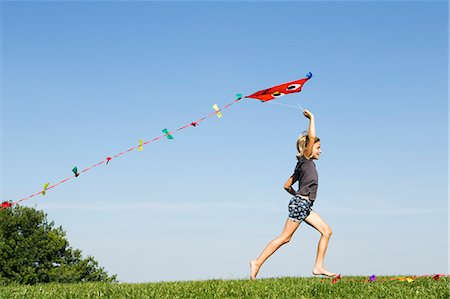 flying kite kids running - Girl playing with kite outdoors Stock Photo - Premium Royalty-Free, Code: 649-06352630