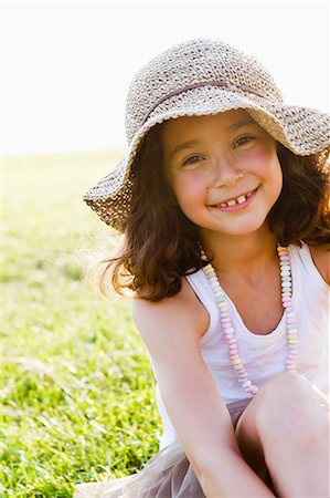 Smiling girl wearing sunhat outdoors Stock Photo - Premium Royalty-Free, Code: 649-06352663