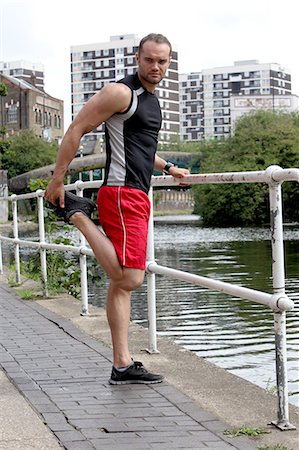 Runner stretching on city street Stock Photo - Premium Royalty-Free, Code: 649-06352717