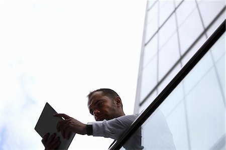 exterior view building - Businessman using tablet computer Stock Photo - Premium Royalty-Free, Code: 649-06352742