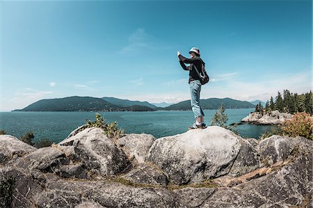 environment canada - Woman taking pictures of rural lake Stock Photo - Premium Royalty-Free, Code: 649-06352775