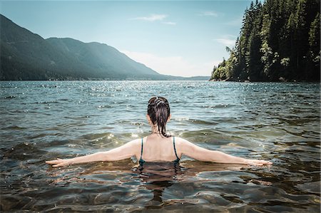 Woman walking in still lake Stock Photo - Premium Royalty-Free, Code: 649-06352773