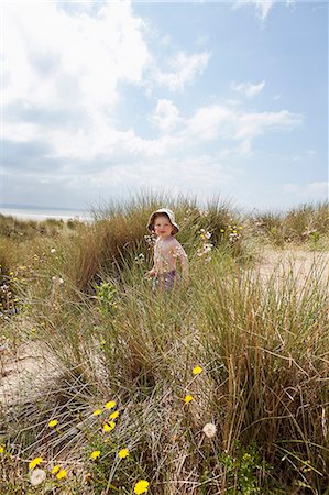 Boy walking in grassy sand Stock Photo - Premium Royalty-Free, Code: 649-06352897