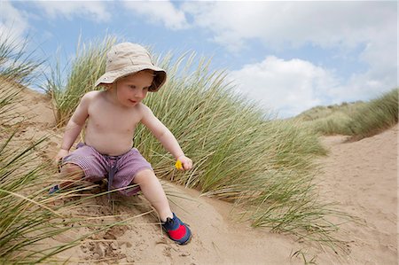 Boy playing on sand dune Stock Photo - Premium Royalty-Free, Code: 649-06352905